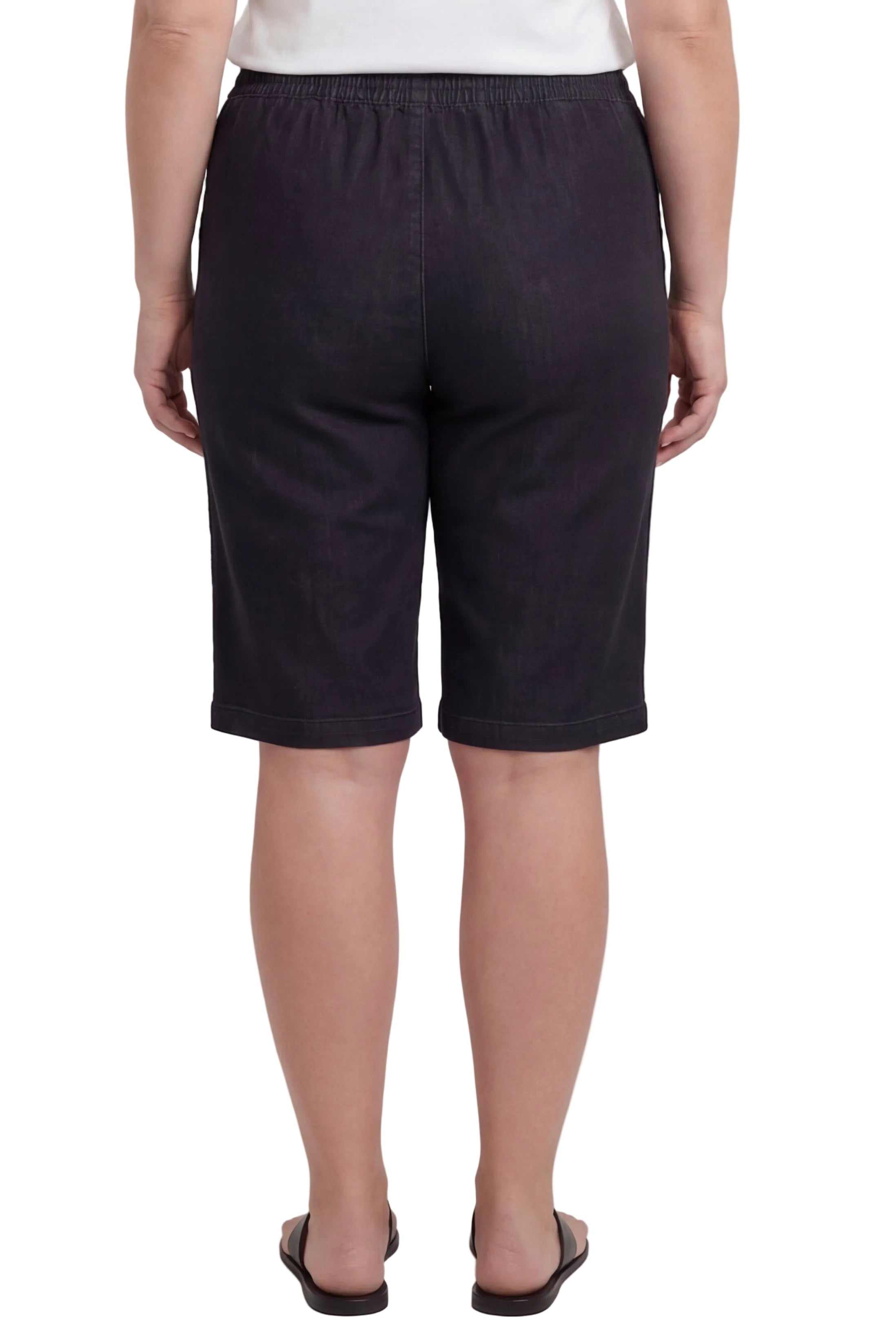 Person wearing black shorts on a white background