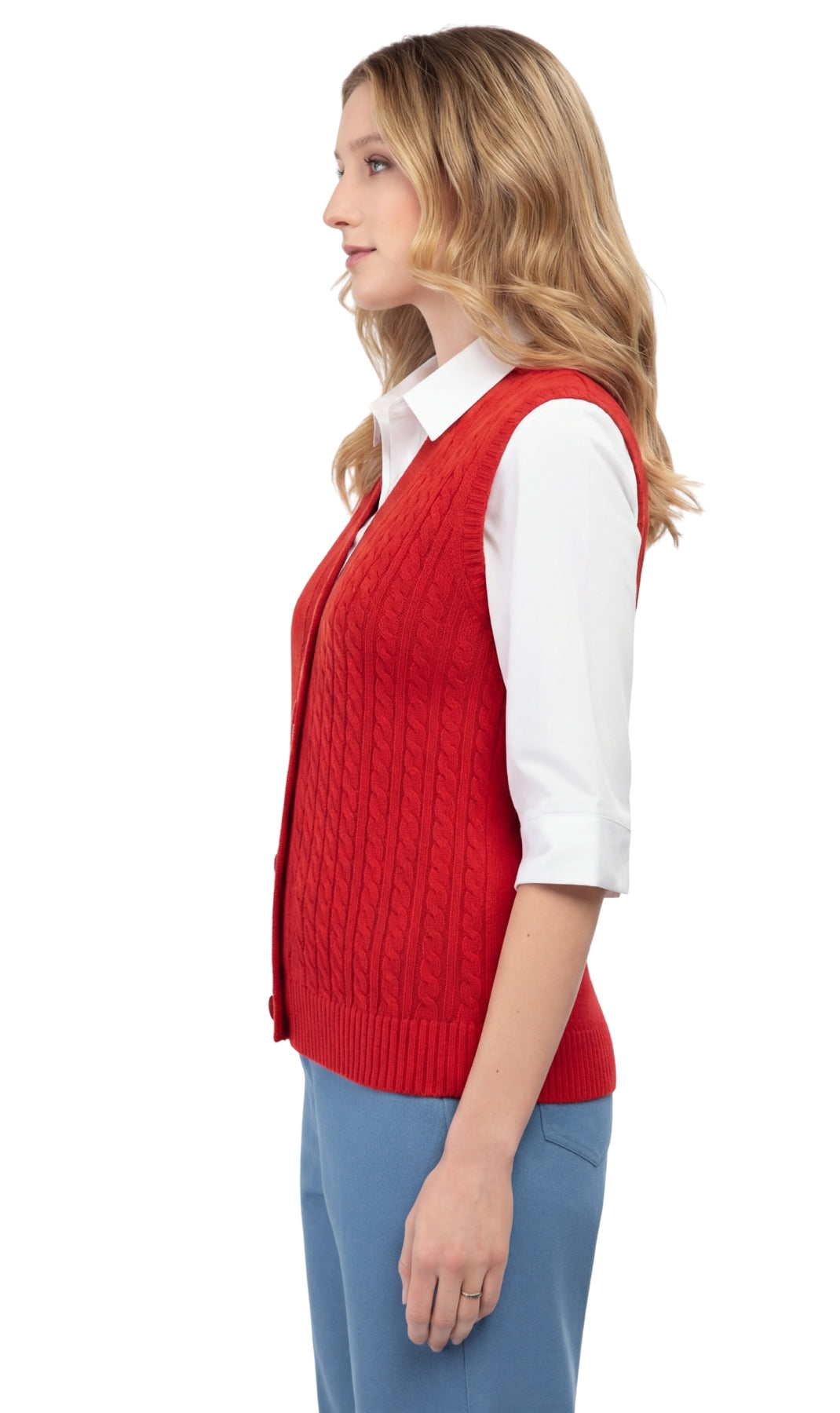 Woman wearing a red cable knit vest over a white shirt on a white background