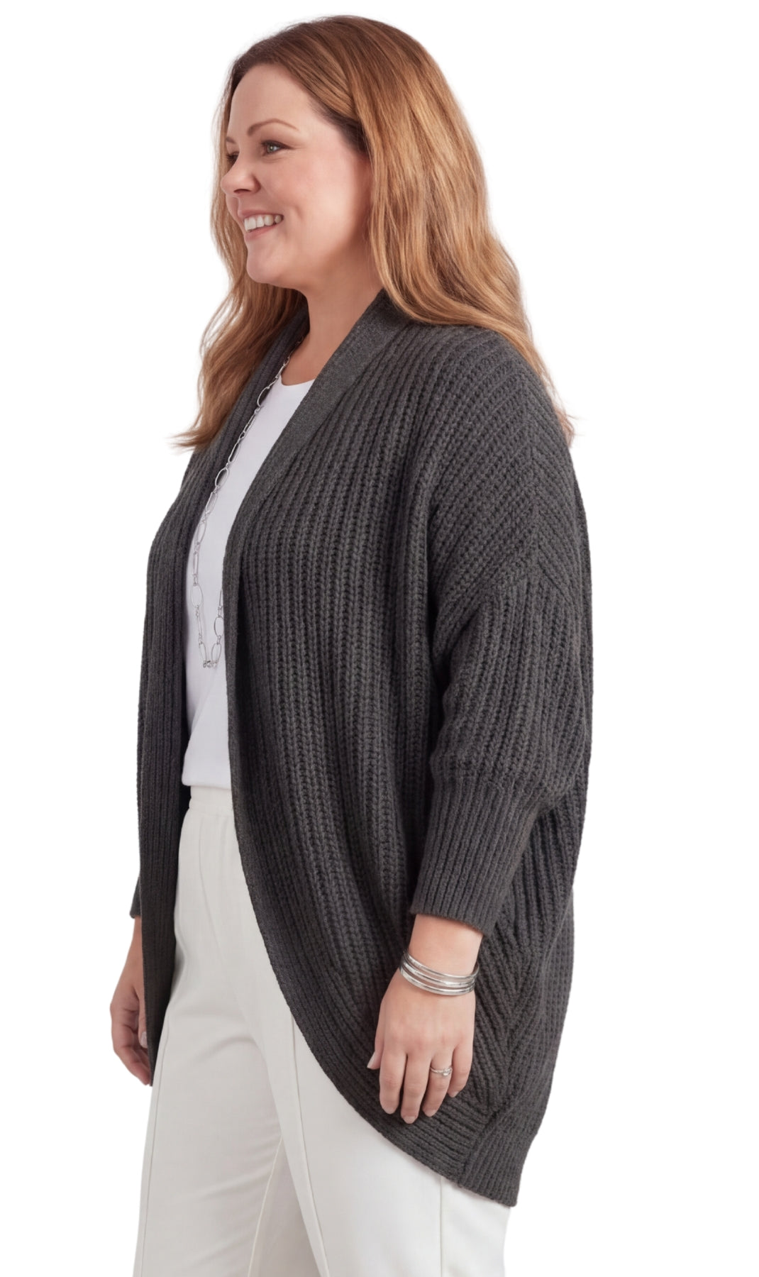 Woman wearing a gray cardigan over a white shirt on a white background