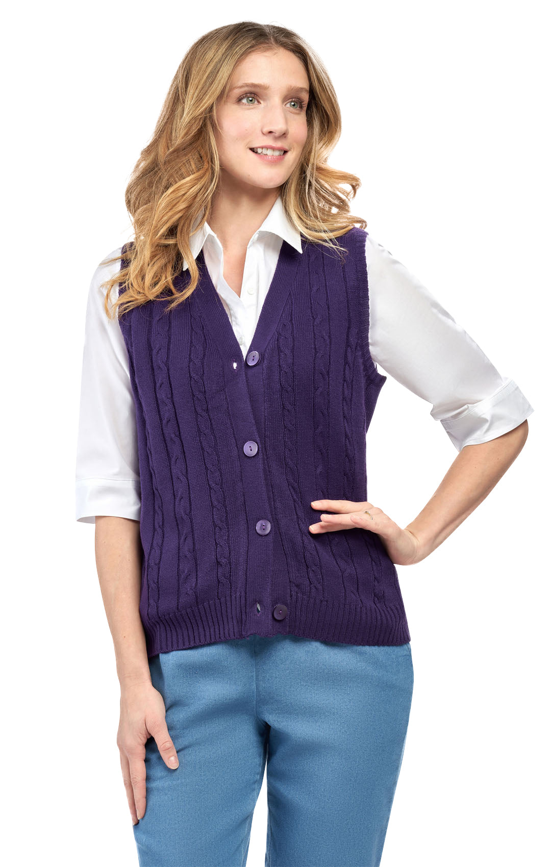 Woman wearing a purple cable knit vest over a white shirt and blue pants on a white background