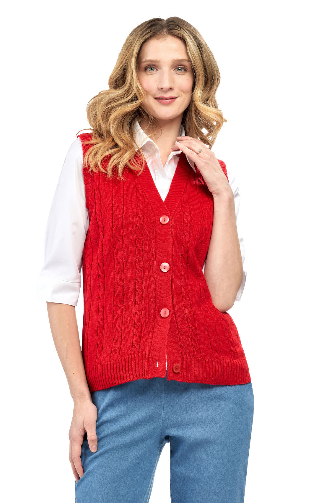 Woman wearing a red sweater vest over a white shirt and blue jeans on a white background